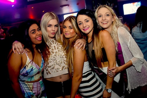 girls & guys celebrating friends birthday on Queenstown party tour pub crawl in nightclub!