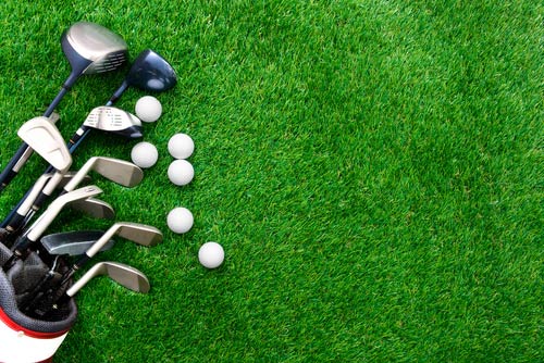 Golf clubs pictured on a green tee