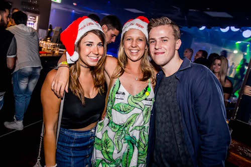 girls and guy Christmas party in silly season in Queenstown bars with big night out pub crawl