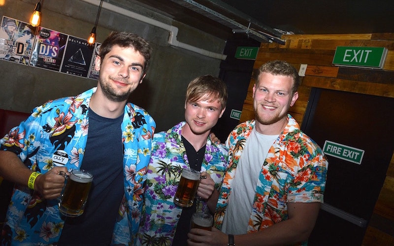 3 Gentlemen in hawaiian shirts with pints in their hand on Waitangi weekend