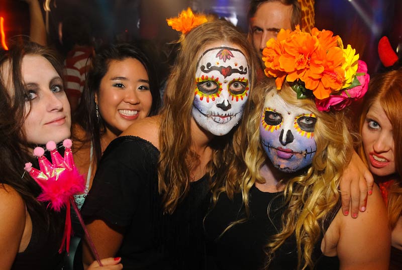 Day of the Dead sugar skulls face painted girls with marigold flower crowns and partying on the big night out pub crawl in Queenstown