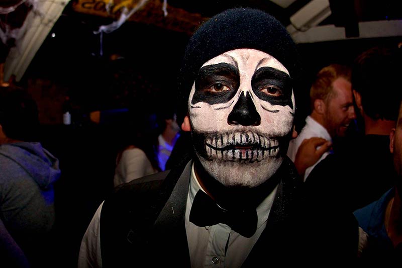 Guy in Hat and Bow Tie with Skull face paint for Day of the Dead Queenstown celebration