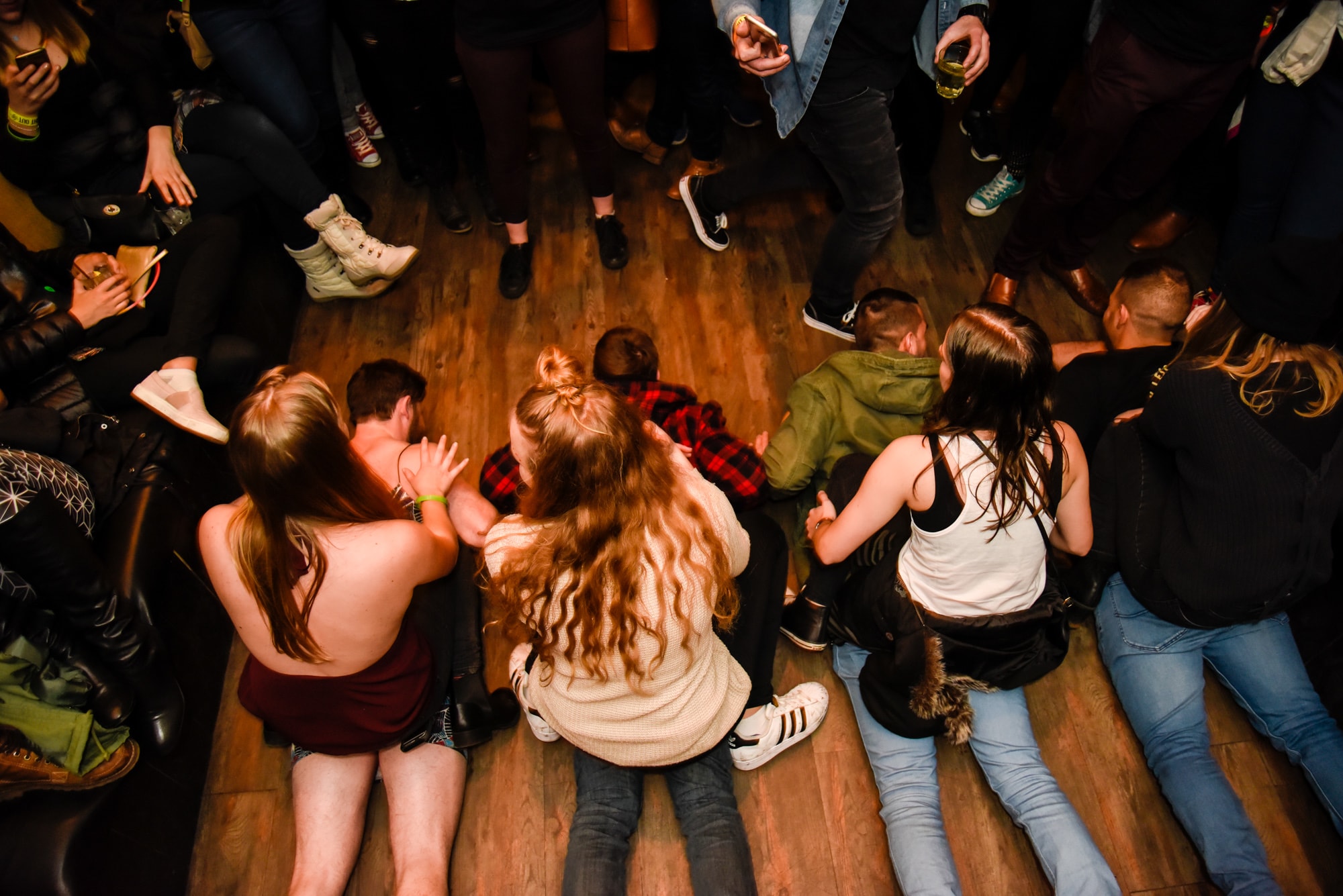 girls sitting on guys on the floor of Queenstown pub with Big Night Out playing an adult party games