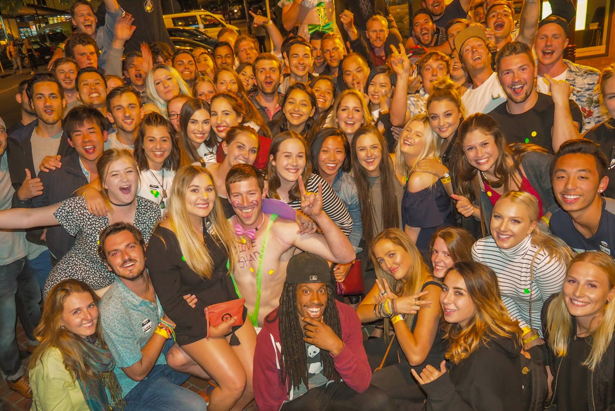 huge group on the big night out pub crawl in Queenstown on Saturday nights having fun bar hopping from club to pub