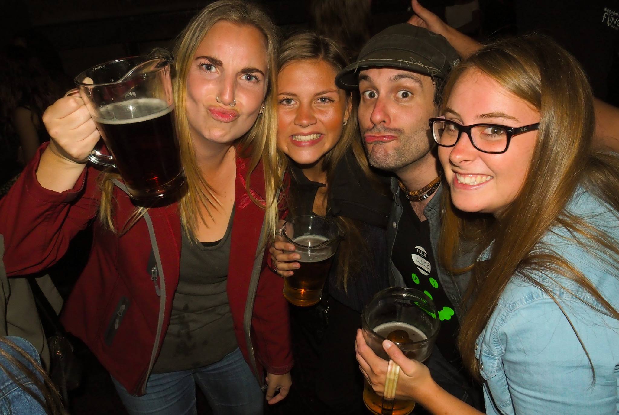 three girls and a lad drinking and having fun on the big night out pub crawl in Queenstown